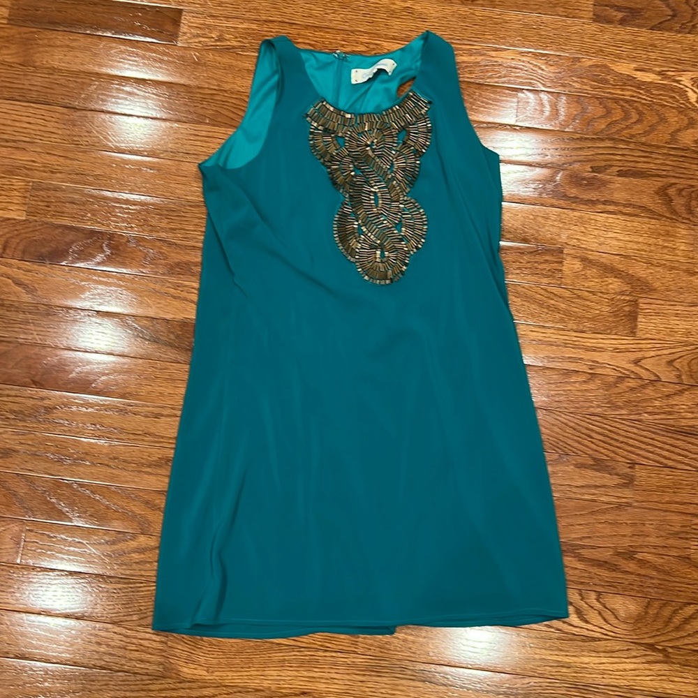 Tourquois dress with bronze bead detailing over the chest.
